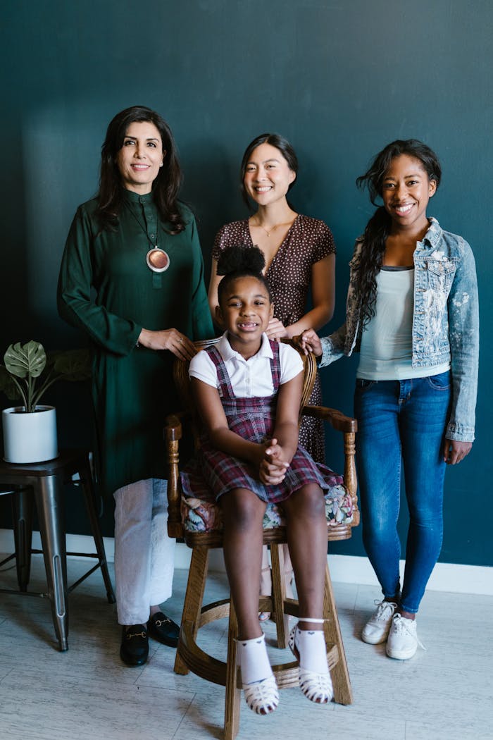 A diverse group of women supporting a young girl